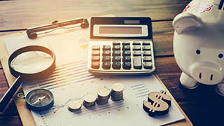 A photo of financial tools such as a calculator and clipboard.