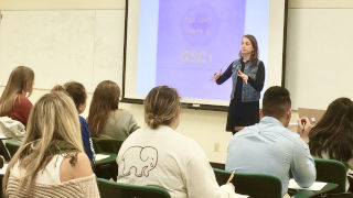 Professor lectures to a classroom of students