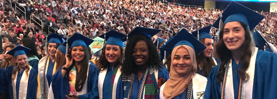 A row of female graduates in the Prudential Center. 