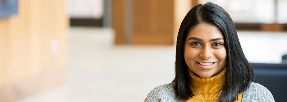 Graduate Student smiling in Bethany Hall. 