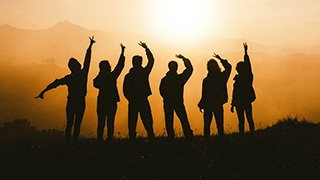 A group of friends watching the sunrise.