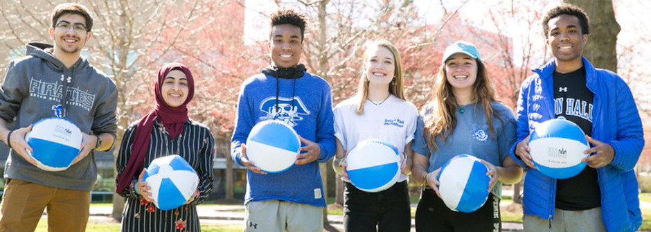 A photo of a group of students holding beach balls