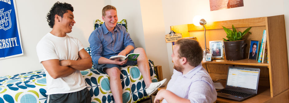 Students talking with a resident assistant. 