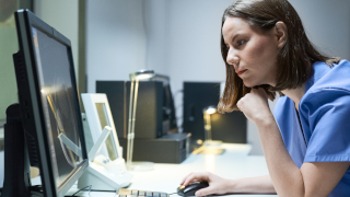 Nursing student looking at a computer.