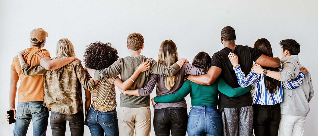 People standing together in a row facing away from us.