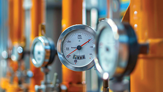 Meters on pipes in an industrial setting.