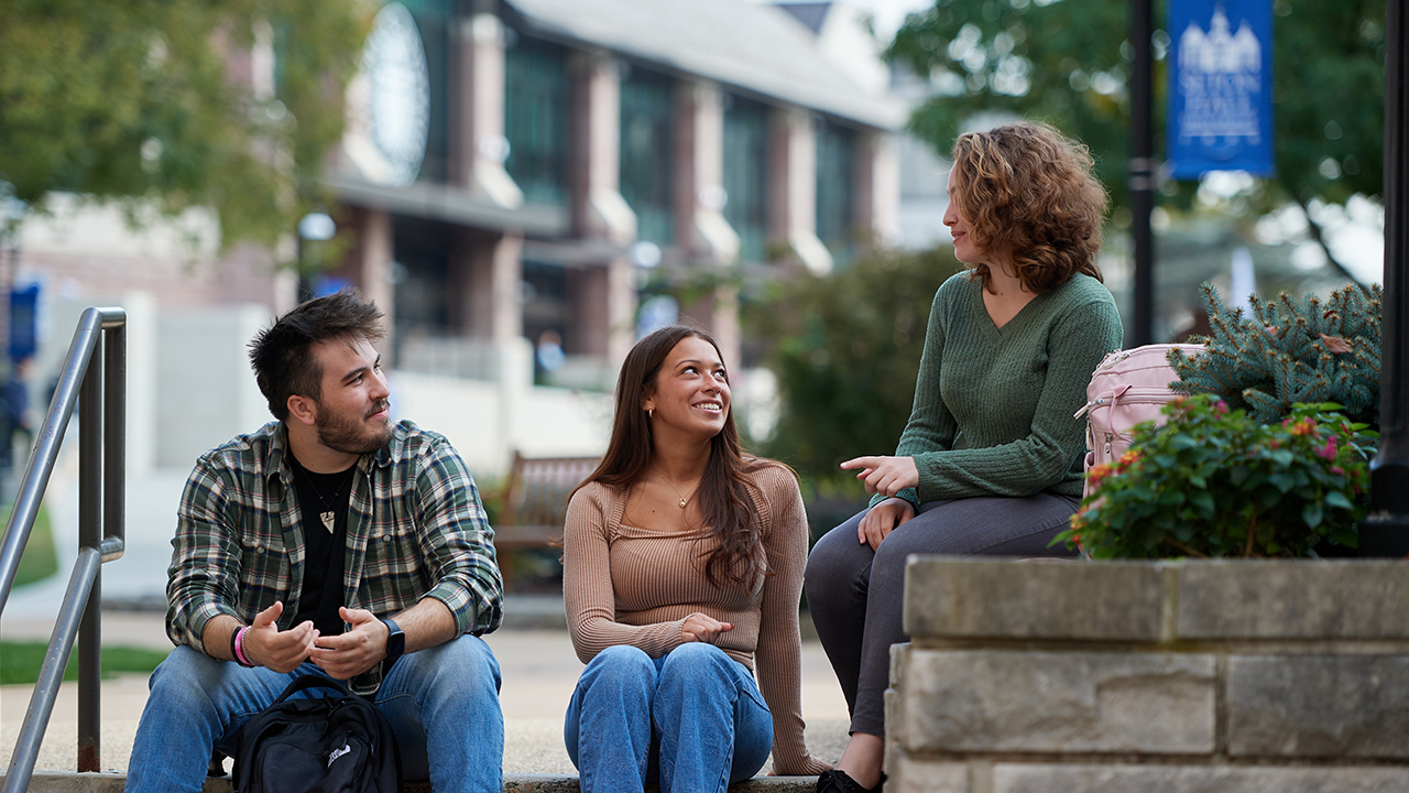 Students sitting on steps on campus