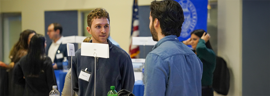 A speaker and a student at the Career Fair.