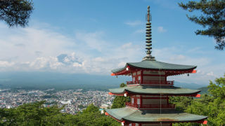 Japanese temple over looking town and mountain.