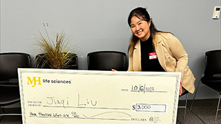 Jiaqi Liu holding sign