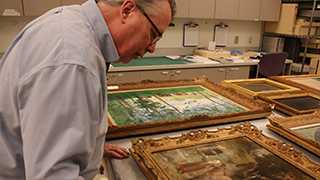 Dean of University Libraries John Buschman reviews the donation.