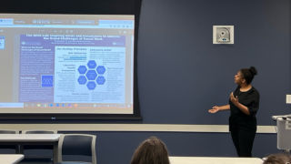 juan rios standing with student alyssa ghansrios presentation