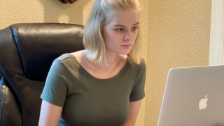 A photo of Kelly Tobin using a laptop.
