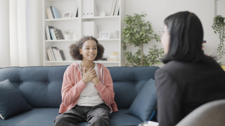 Girl talking to doctor in office