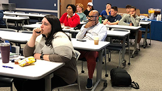 Dr. Vega presenting his dissertation to students & facultyStudents listening to Dr. Vega's presentation on his dissertation