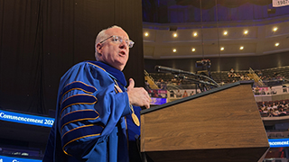 Monsignor Reilly addressing the graduates.