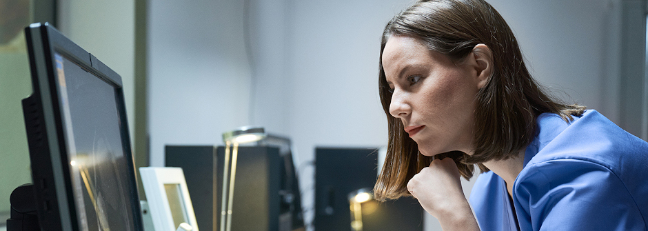 Nursing student looking at a computer.