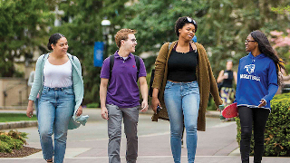 Students talking and walking on campus. 