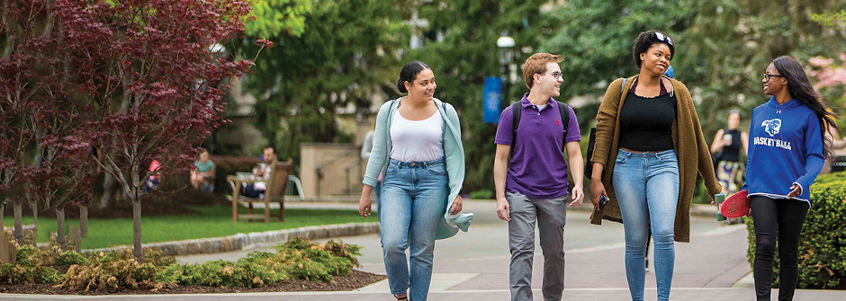 Students talking and walking on campus.