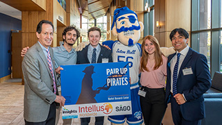group at the Pair-Up with Pirates event holding a sign with the event's name