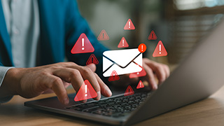Email warning sign on laptop
