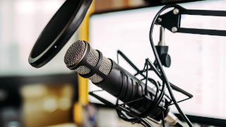 Image of a microphone in a studio.