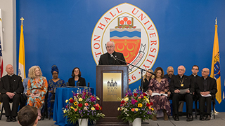 President Monsignor Joseph R. Reilly giving a speech.