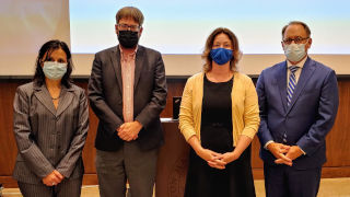 Rhonda Quinn standing with President Nyre and other faculty members