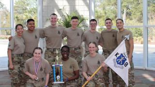 Image of members of the Pirate Battalion holding a trophy