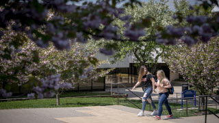 Students walking in front of the Arts and Sciences and Schwartz buildings. 