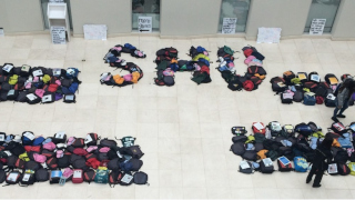 A photo of backpacks on the floor.