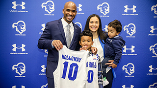 Seton Hall Pirates men's basketball head coach Shaheen Holloway smiling while coaching.