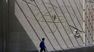 a wall with drawings and names of scientific majors at McNulty Hall