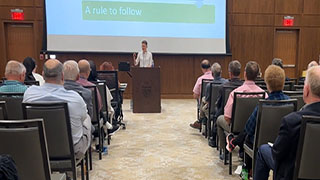 The Sixth Annual Conference of The Society of Catholic Scientists. A room full of guests sit to observe the presentation.