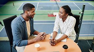 Image of a sports player talking to a supervisor.