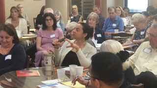Image of a woman asking a question at the St. Catherine retreat