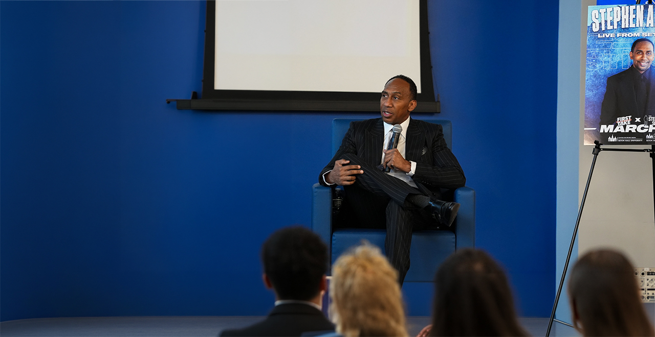 Stephen A. Smith seated while engaging with Seton Hall students