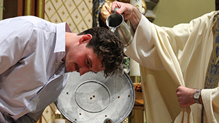 Student being renewed in the waters of Baptism (Photo by Genna Nadal).