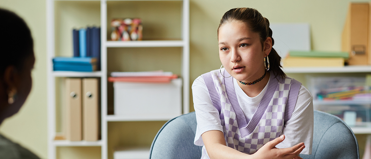 Image of a young woman in a woman's counseling office.