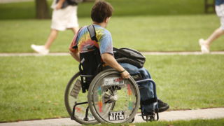 Student in wheelchair on campus. 