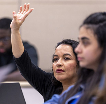Student raising their hand in class.