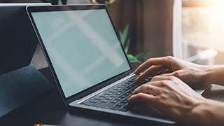 A student types on a computer.