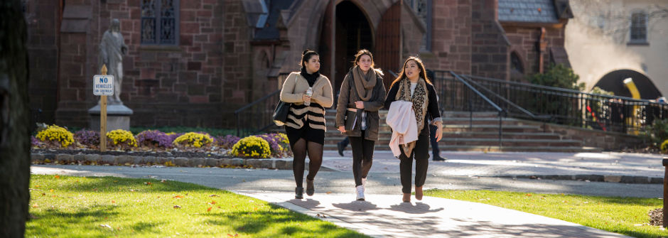 Students walking in front of the chapel. 