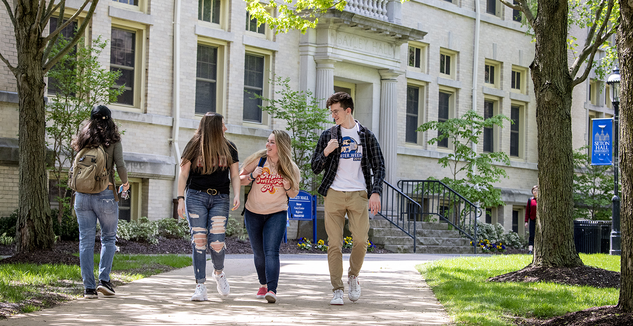 Students walking on campus near Bayley Hall.
