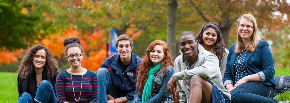 Students sitting on the green. 