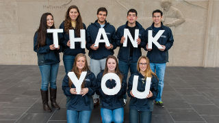 Members of the Student Alumni Association holding up letters spelling out 