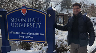 Tomás near the Seton Hall sign