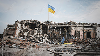 Ukrainian flag over a destroyed structure