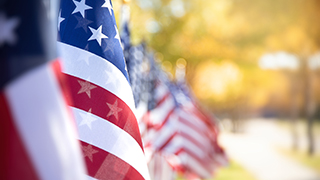 A photo of flags waving along a street.