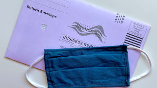 Mail-in ballot with a blue mask placed on top of it